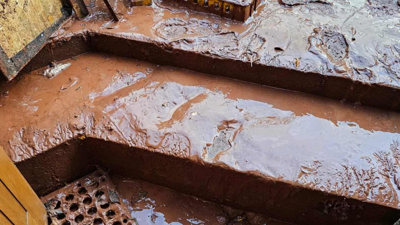 A picture of a muddy step inside of the pub. The mud is thick on the steps. 