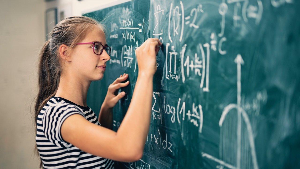 Girl writing on board