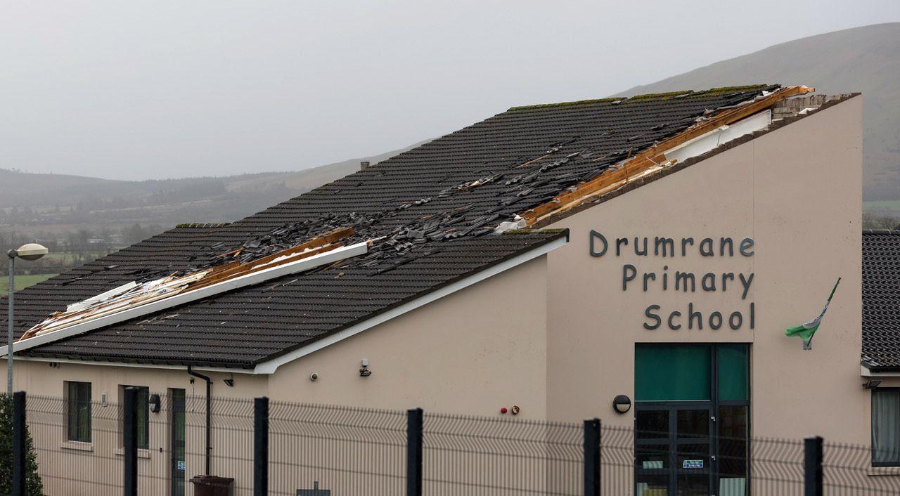 A part of the roof on the school has been torn away. Tiles are spread right across the length of the roof.