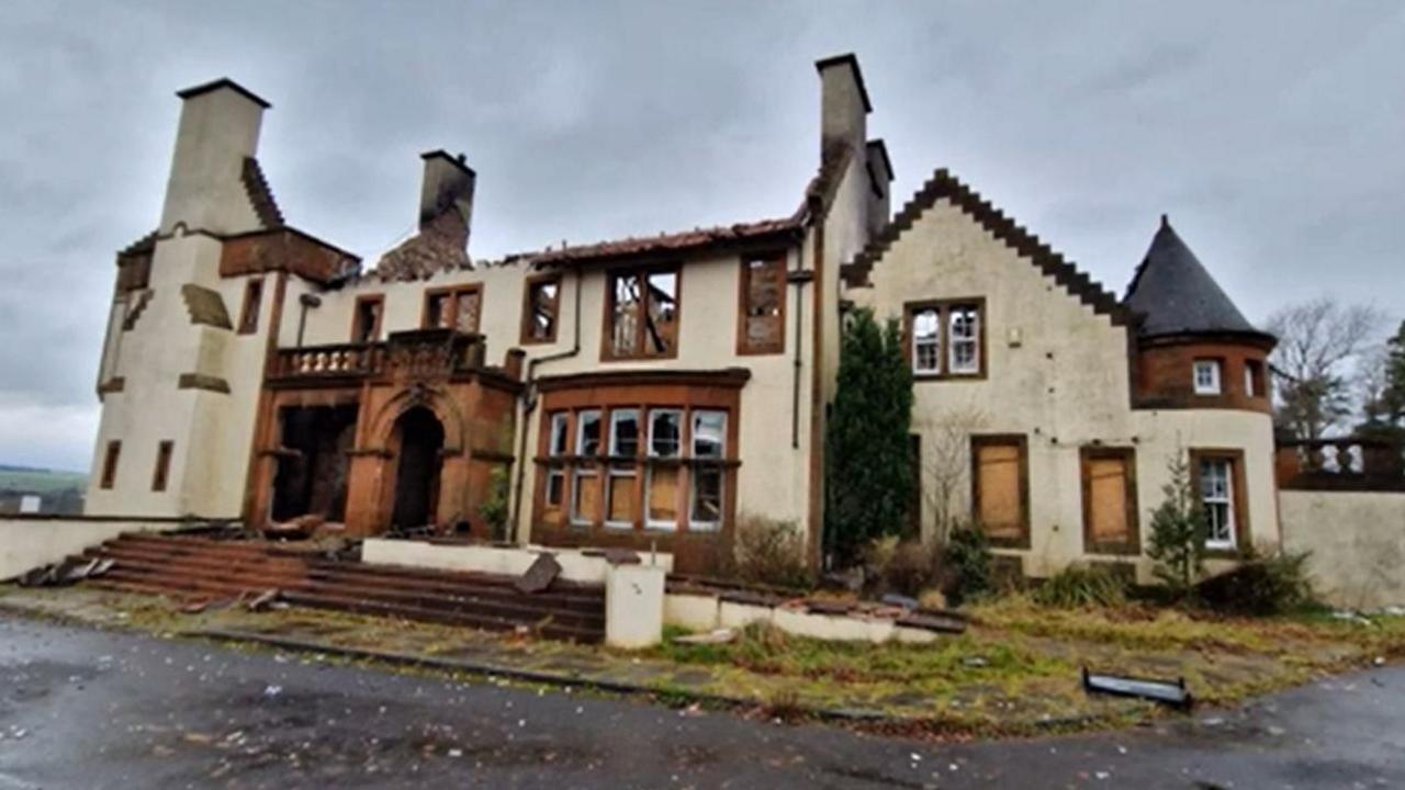 Wide image of the gutted former hotel