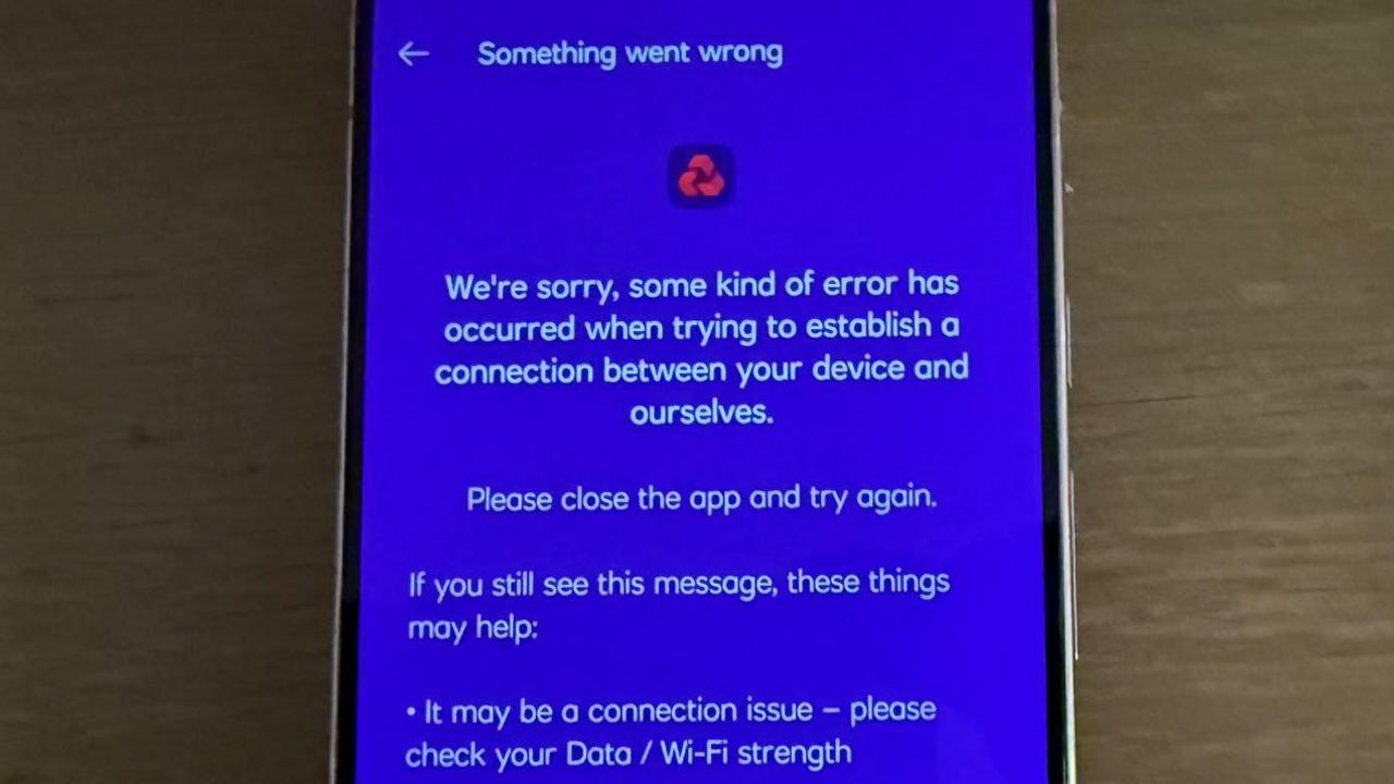 A phone displaying an error message with the NatWest logo. It reads: "Something went wrong. We're sorry, some kind of error has occurred when trying to establish a connection between your device and ourselves. Please close the app and try again. If you still see this message, these things may help: It may be a connection issue - please check your Data/Wi-Fi strength."