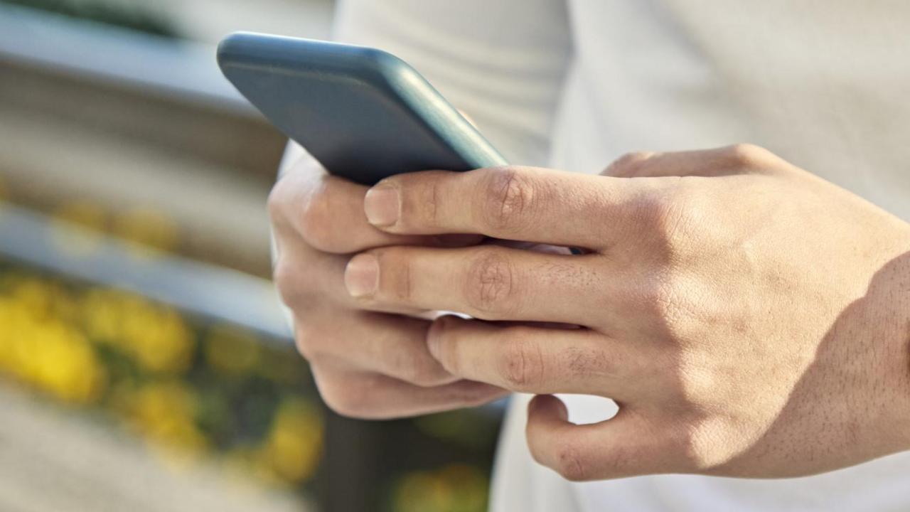 A man holding a phone (stock image)