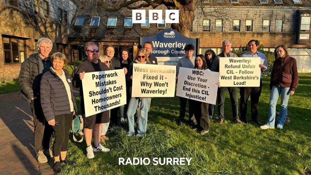A group of residents stand outside Waverley Borough Council Offices holding placards with slogans like "Paperwork Mistakes Shouldn't cost Homeowners thousands"