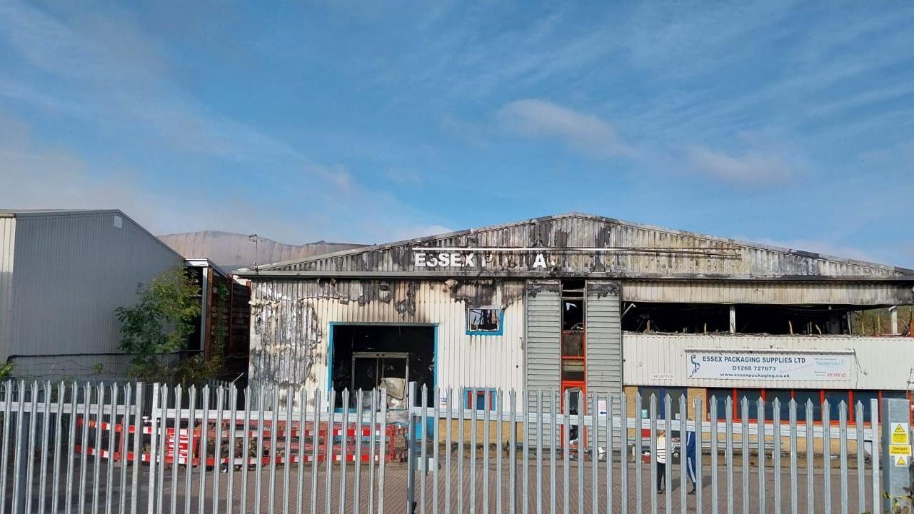 The metal-clad building that houses Essex Packaging Solutions showing the badly damaged roof  and you can no longer see the firm's name in full on the front.