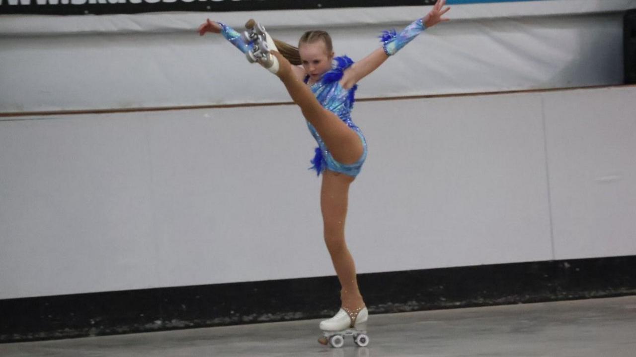 A girl performing an artistic routine on roller-skates