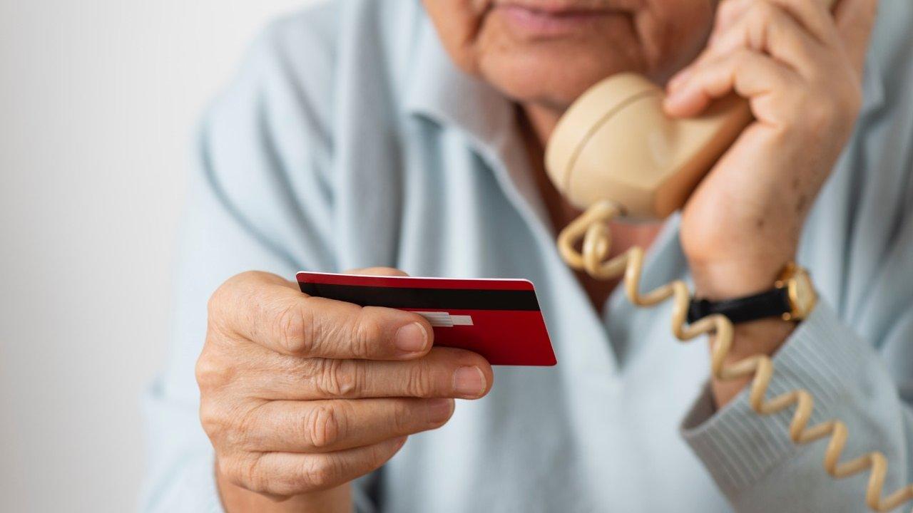 Person holding phone and credit card