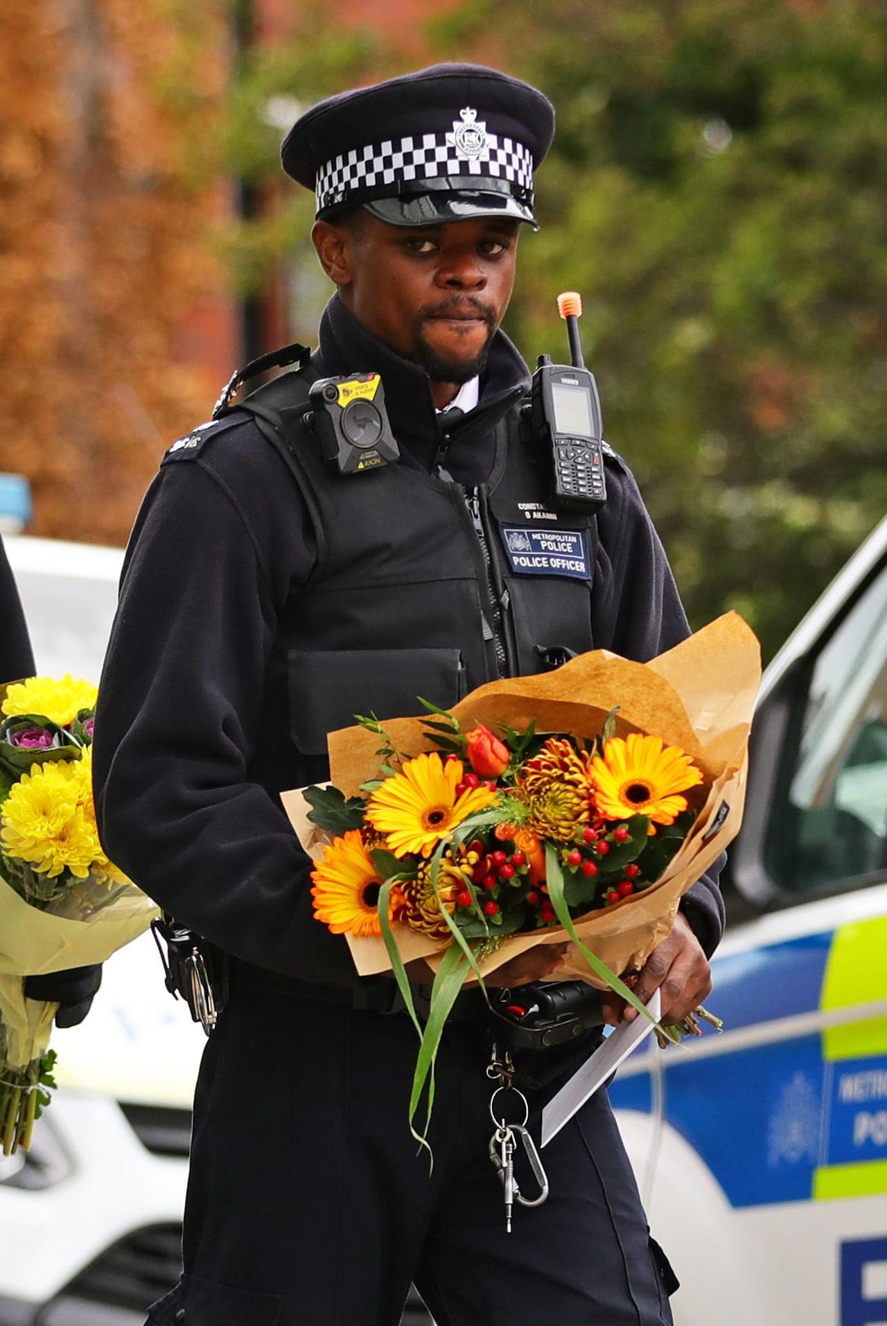 Officer holding flowers