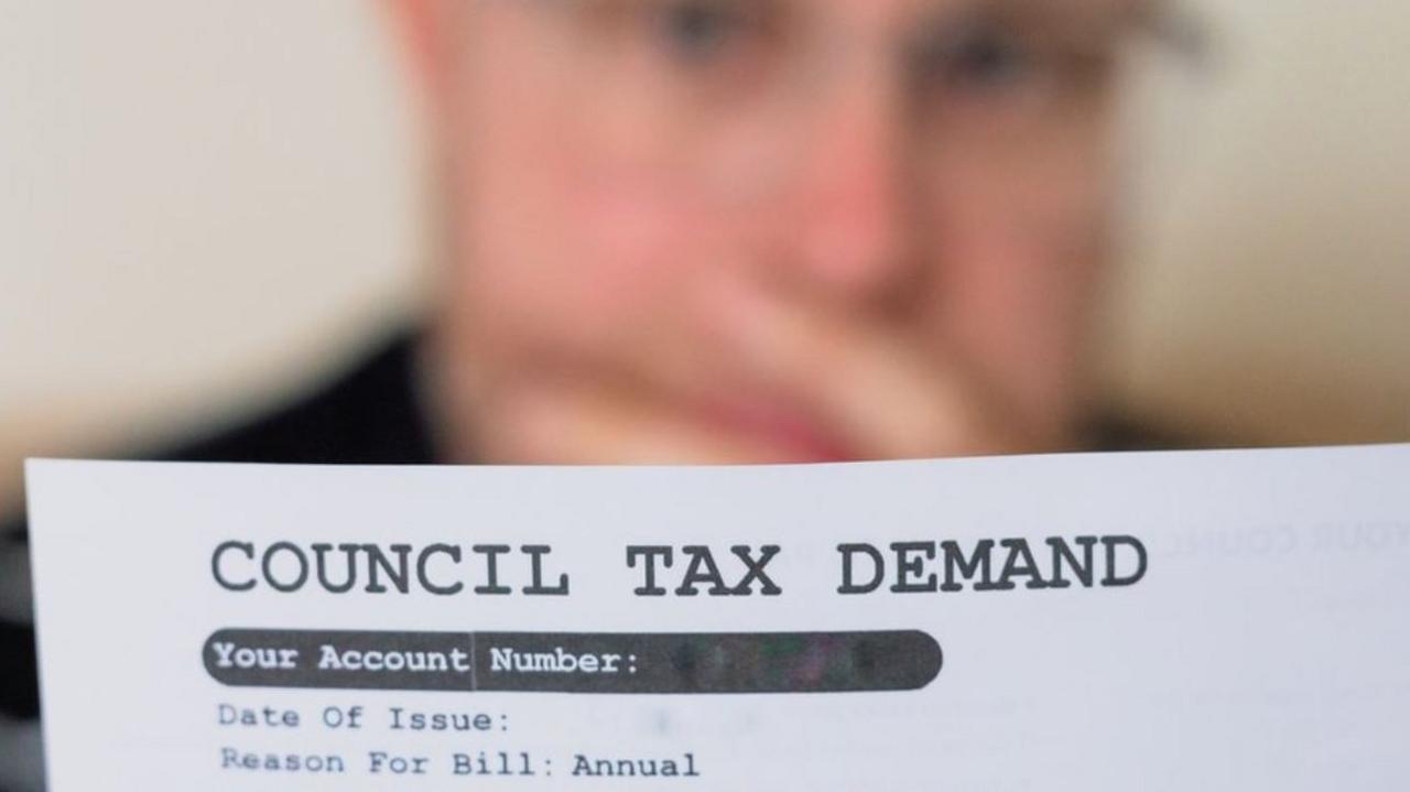 A man looking at his council tax bill