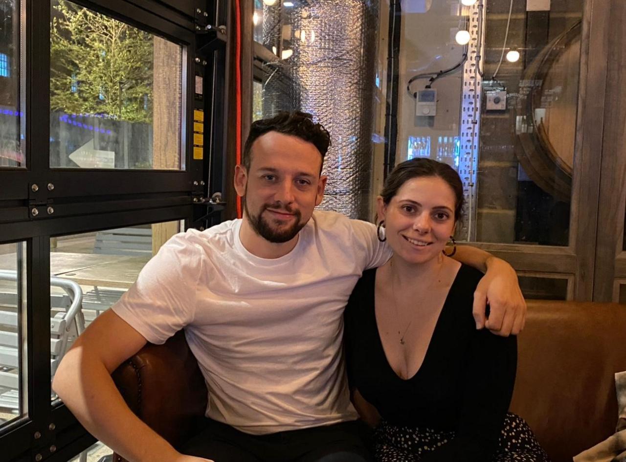 Charlotte Ballard sitting with her partner at a restaurant