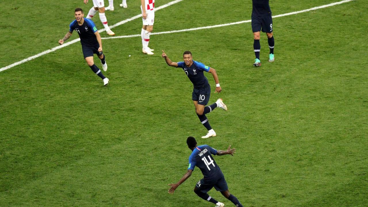 Kylian Mbappe wheels away to celebrate after scoring in the World Cup final against Croatia