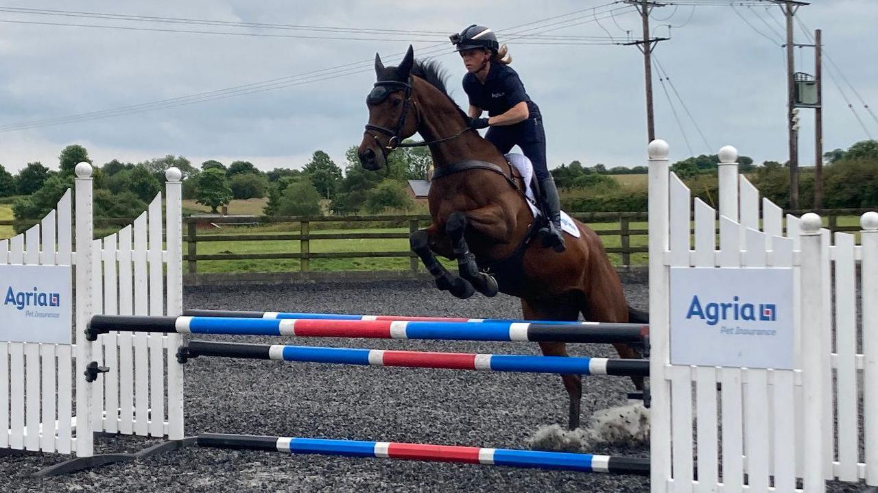 Ros Canter riding a horse over a jump