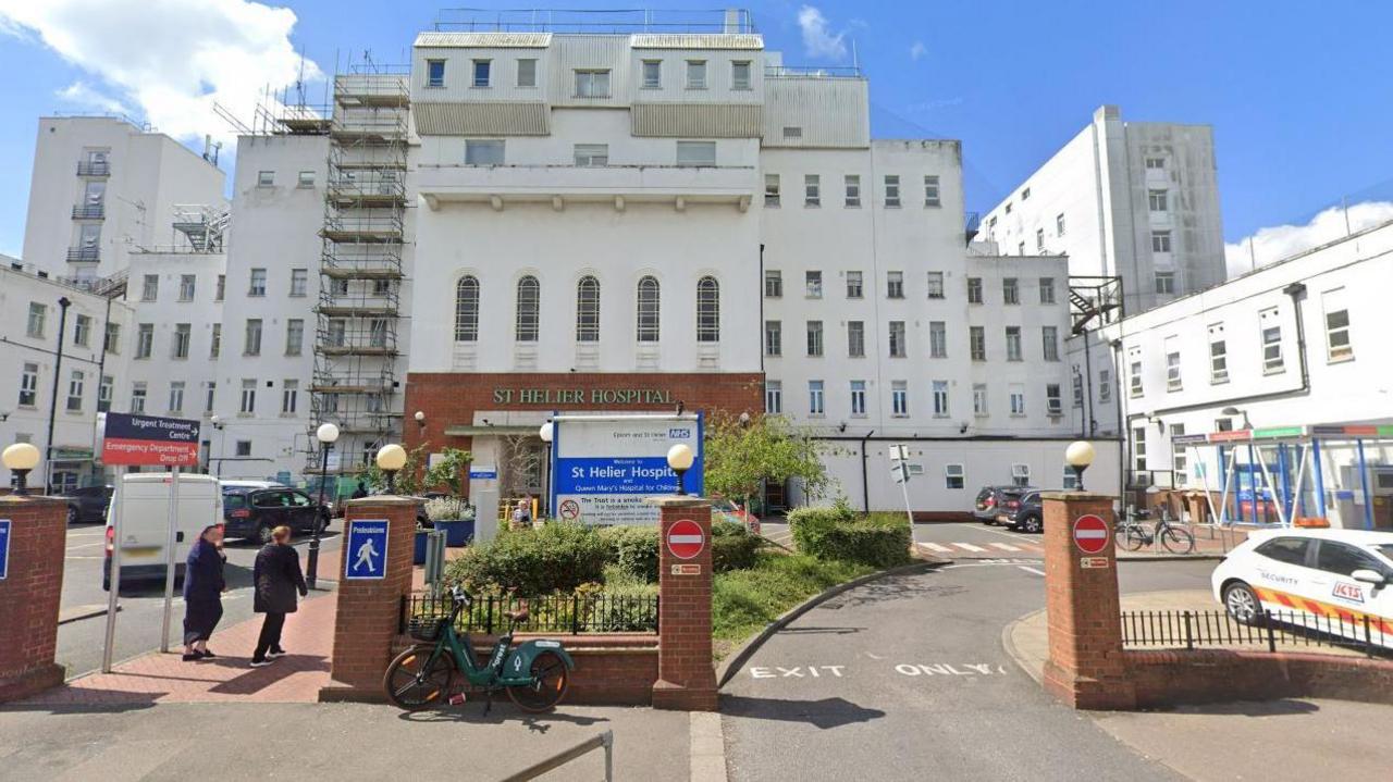 A general view of the exterior of St Helier Hospital shows white building with red brick entrance and wall