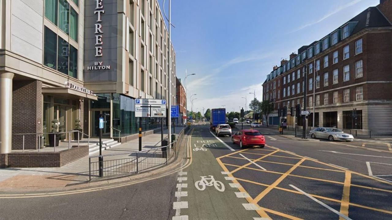 Google Street View of Ferensway in Hull looking towards the junction with Portland Place with the cycle and bus lane marked in green paint on the road. There is a DoubleTree By Hilton hotel on the left.