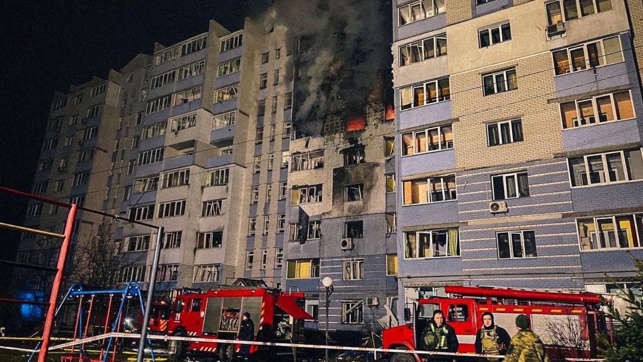 Smoke gushes from a burning residential building in Hlevakha, Kyiv region, Ukraine, after a reported Russian drone strike. Emergency workers stand outside fire engines.