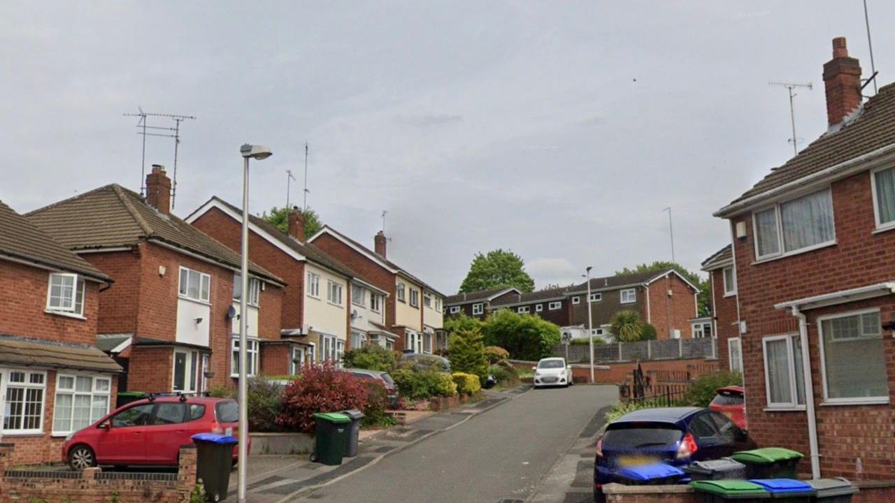 A street view of Middlemist Grove with semi-detached houses on either side of the road.