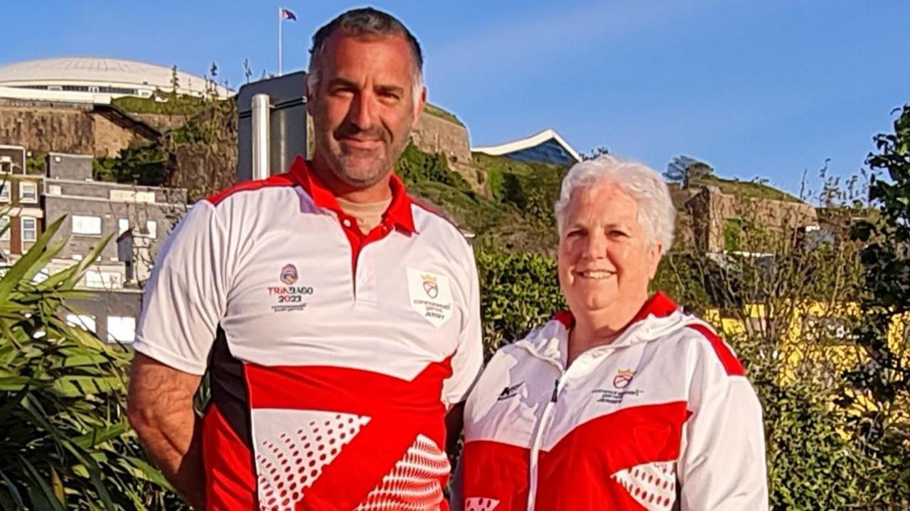 Andy Hamon (left) and Jean Cross photographed in Liberation Square in St Helier wearing Jersey tracksuits