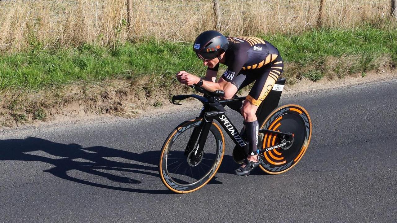 Donald Brooks cycling during a half-Ironman