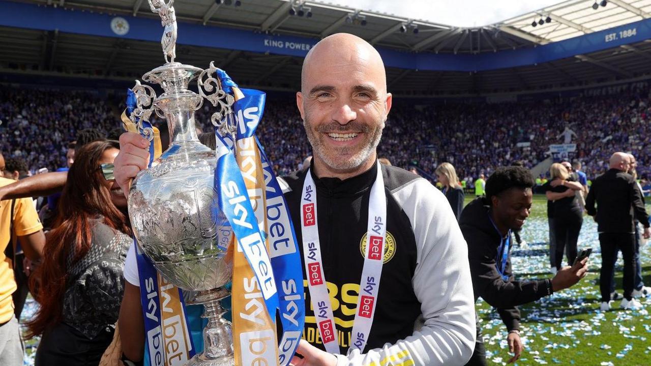 Enzo Maresca celebrates with the Championship trophy