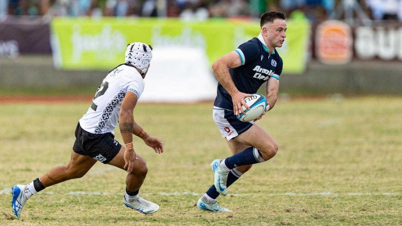 Fergus Burke tries to run past a defender