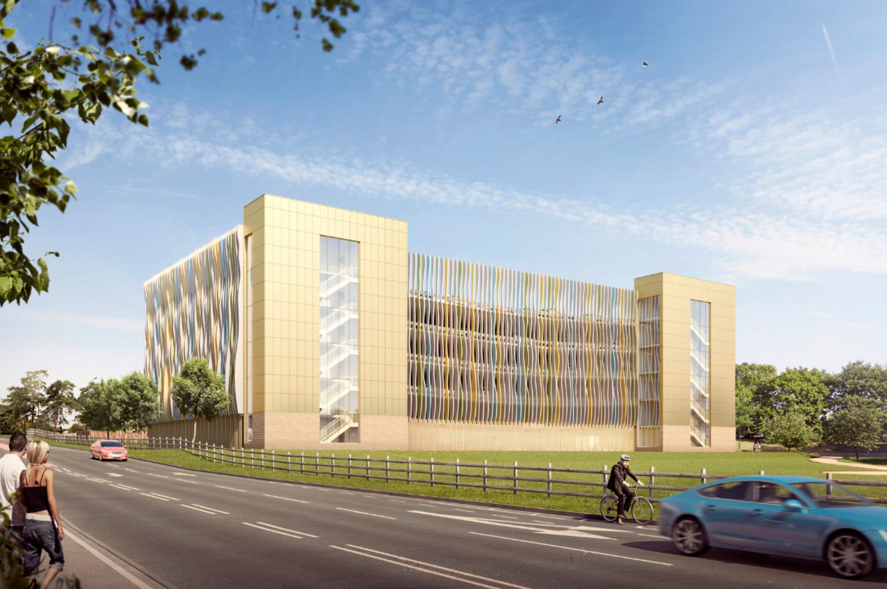 An artist's impression of the new muti-storey car park showing a four storey high building with a lift block. It has a multi coloured cladding.