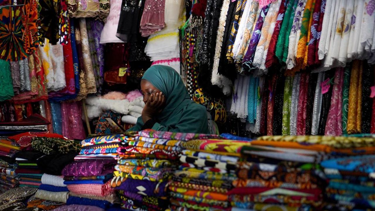 A woman looking on her phone at a market