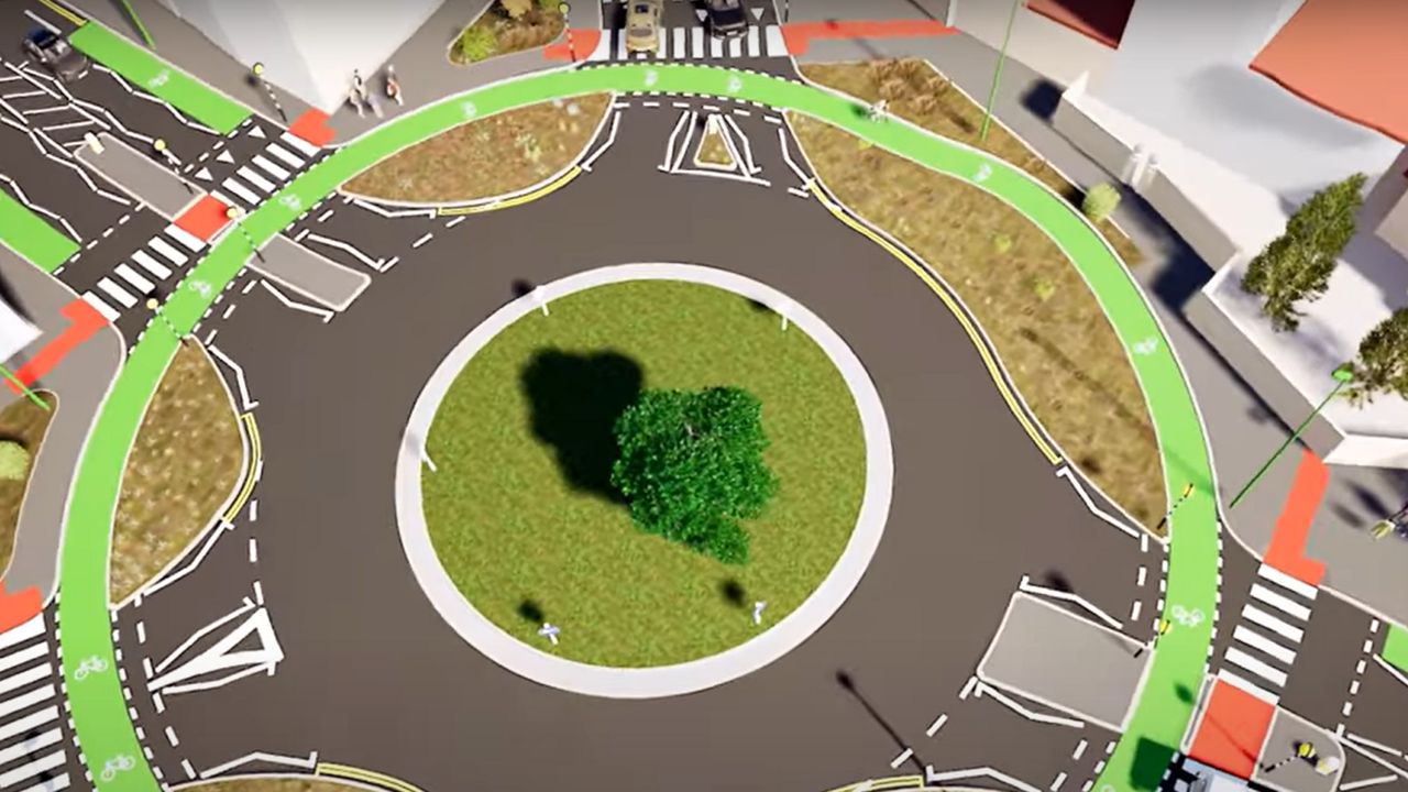 Illustration shows a green painted cycle lane around the edge of the roundabout and zebra crossings on each exit 