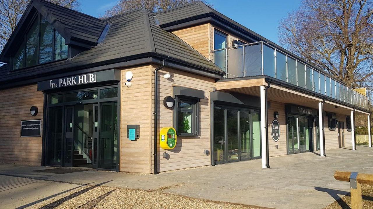 A large community hub, named Park Hub. It is a two-storey building with a balcony.