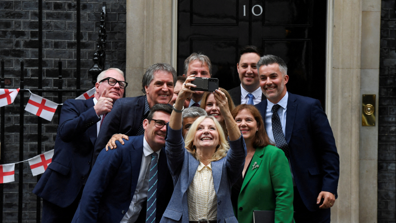 11 English regional mayors pose for a selfie photo outside downing street