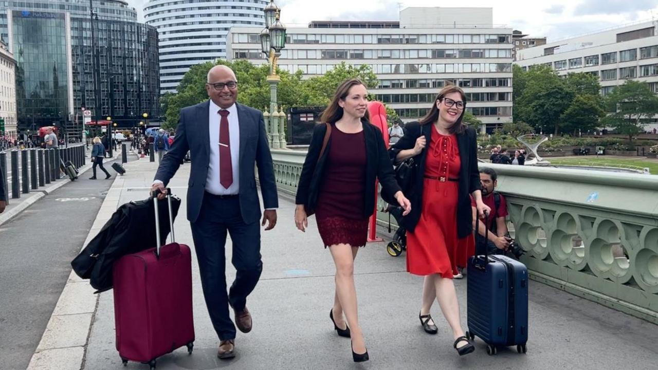 Baggy Shanker, Catherine Atkinson and Linsey Farnsworth head over Westminster Bridge on the way to the House of Commons