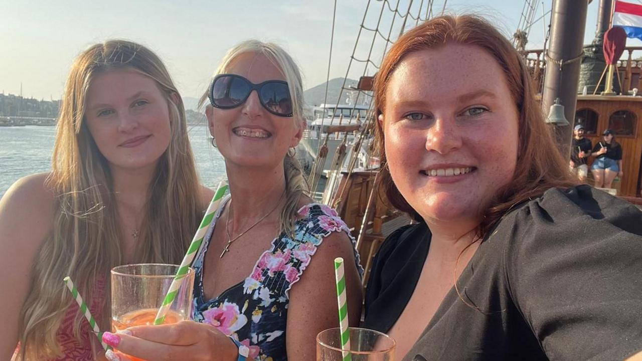 Adele says Tallie (right) with her mum and sister on holiday