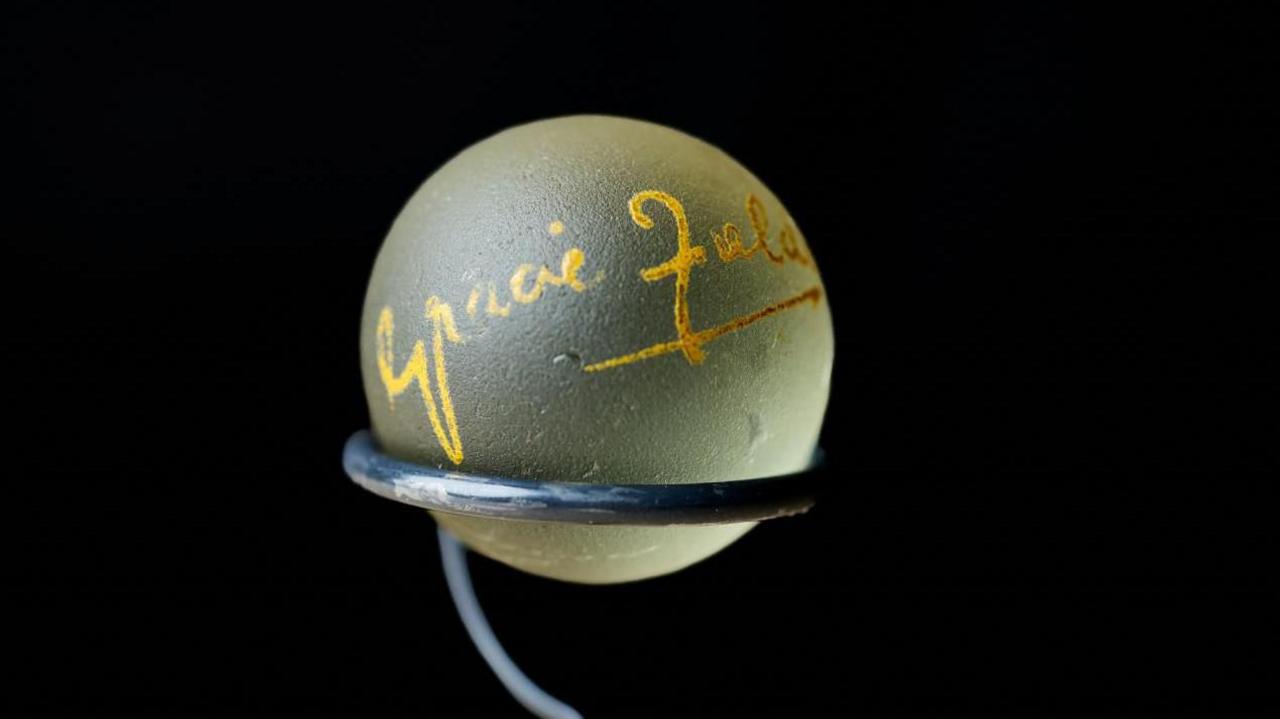 A large glass marble signed by Grace Fields