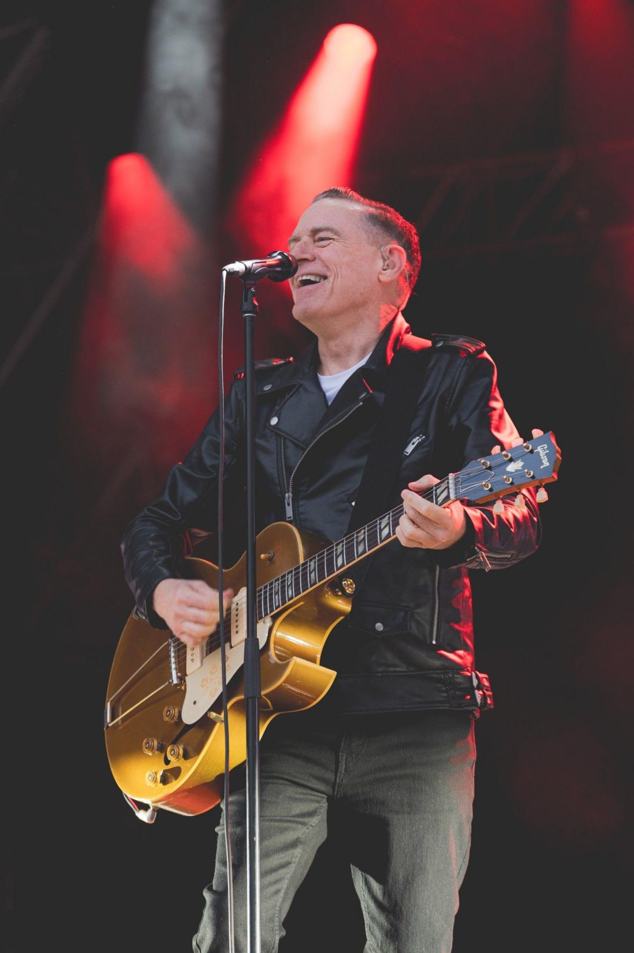 Bryan Adams playing the guitar