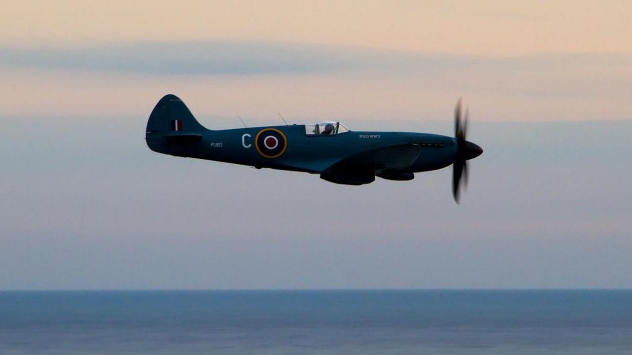 A Spitfire being flown over the sea