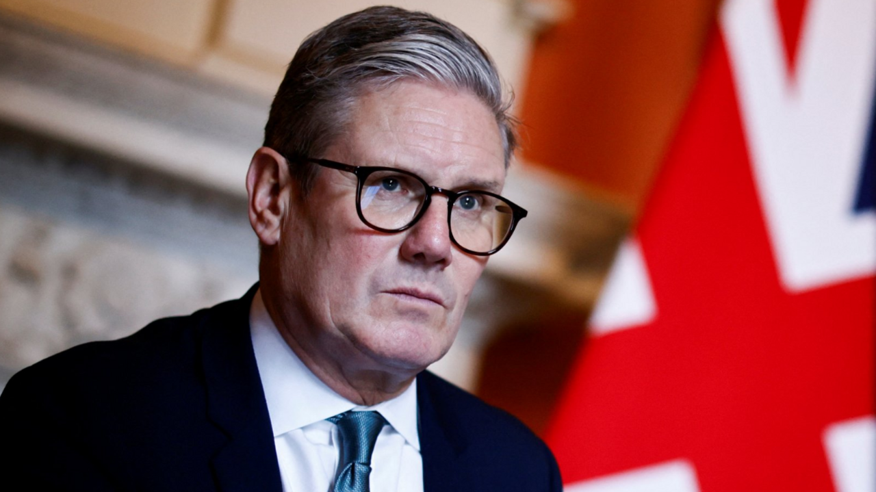 UK Prime Minister Sir Keir Starmer pictured in front of a Union Jack flag