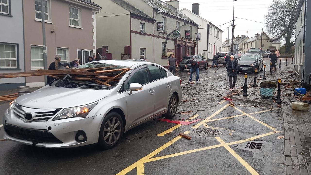 Car with wood through its windscreen 