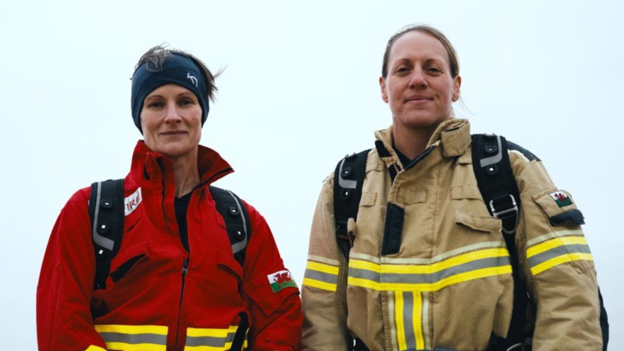 Georgina Gilbert and Rebecca Openshaw-Rowe in full fire kit on the beach