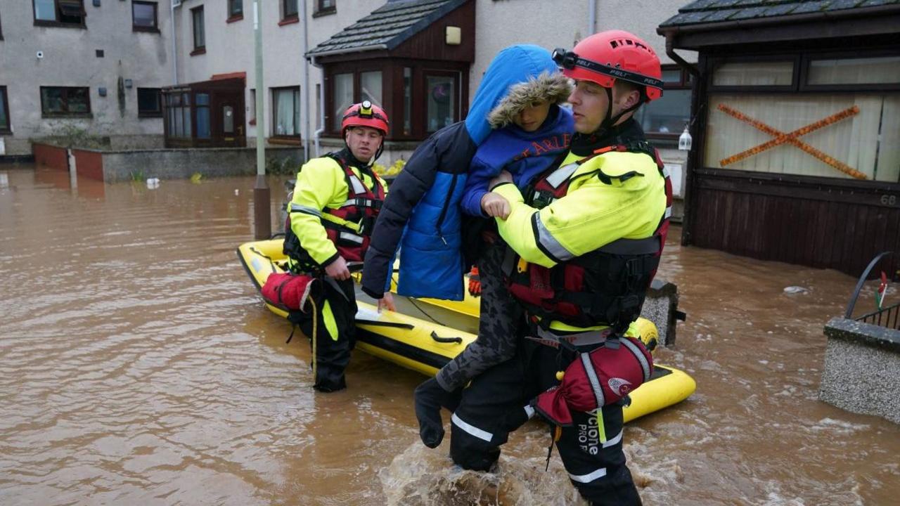 A child is rescued during Storm Babet in Brechin