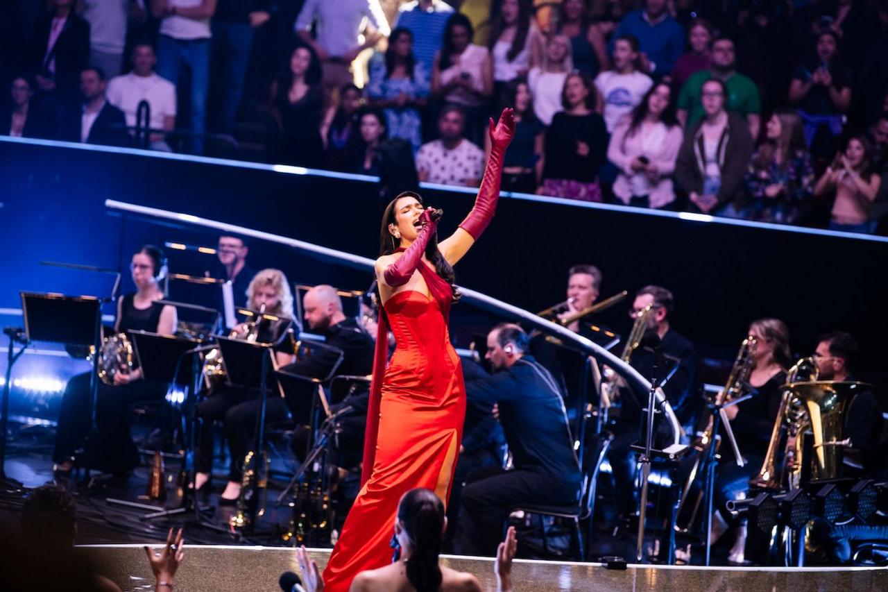 Dua Lipa performs in a red John Paul Gaultier dress at the Royal Albert Hall