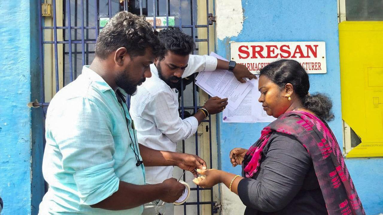A state health official sticks a notice outside the Sresan Pharmaceutical factory whose Coldrif cough syrup has been linked to the deaths of 17 children in Madhya Pradesh, in Chennai, India, October 7, 2025