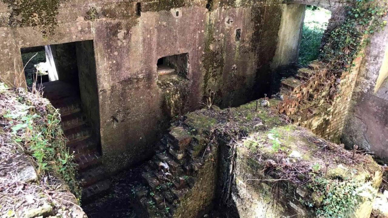 Some stairs around abandoned run down buildings in the gunpowder works