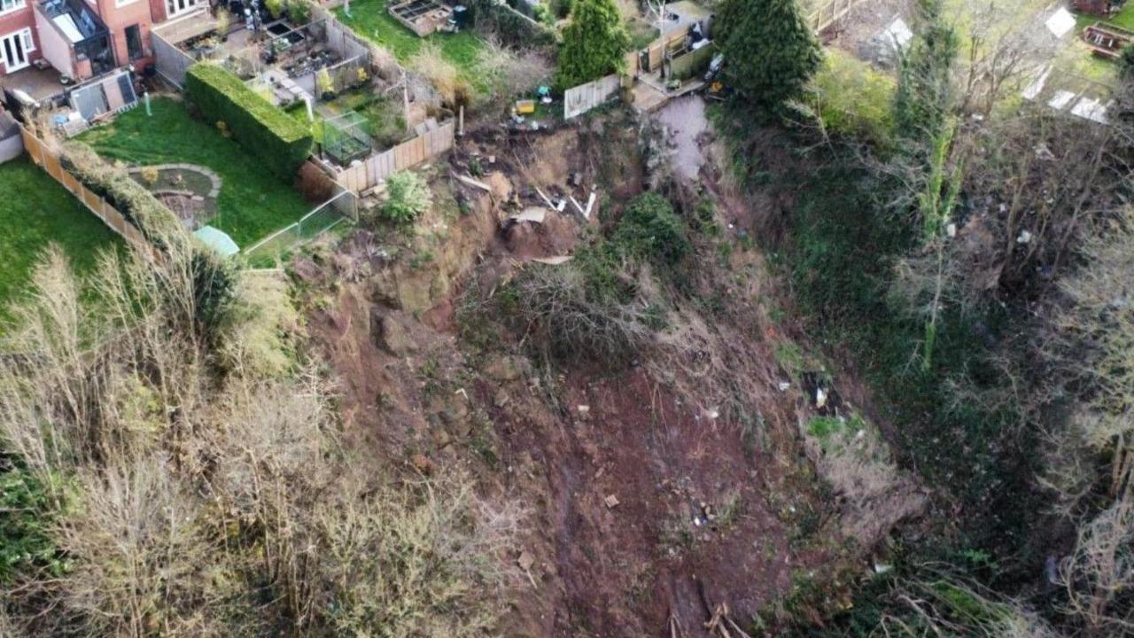 Landslip is visible in the bottom two thirds of the image. A garden and parts of other gardens and houses are at the top.