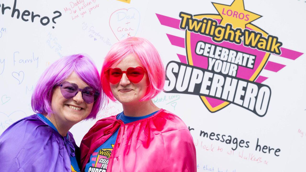 Two participants in pink and purple costumes