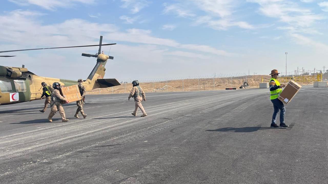 Medical supplies and baby formula are unloaded from a Jordanian helicopter at an airstrip in Israeli-held southern Gaza (28 January 2025)