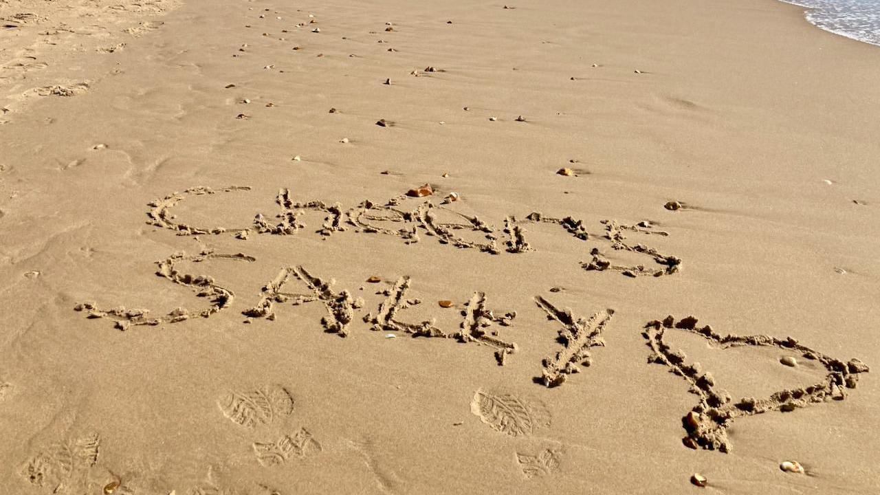 A sandy beach with the words "Cheers Sally" and a love heart drawn. It is in relation to Sally Taylor hosting her final BBC South Today this week.