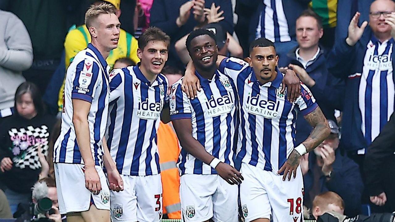 Four West Bromwich Albion players celebrate Josh Maja's goal against Plymouth Argyle.