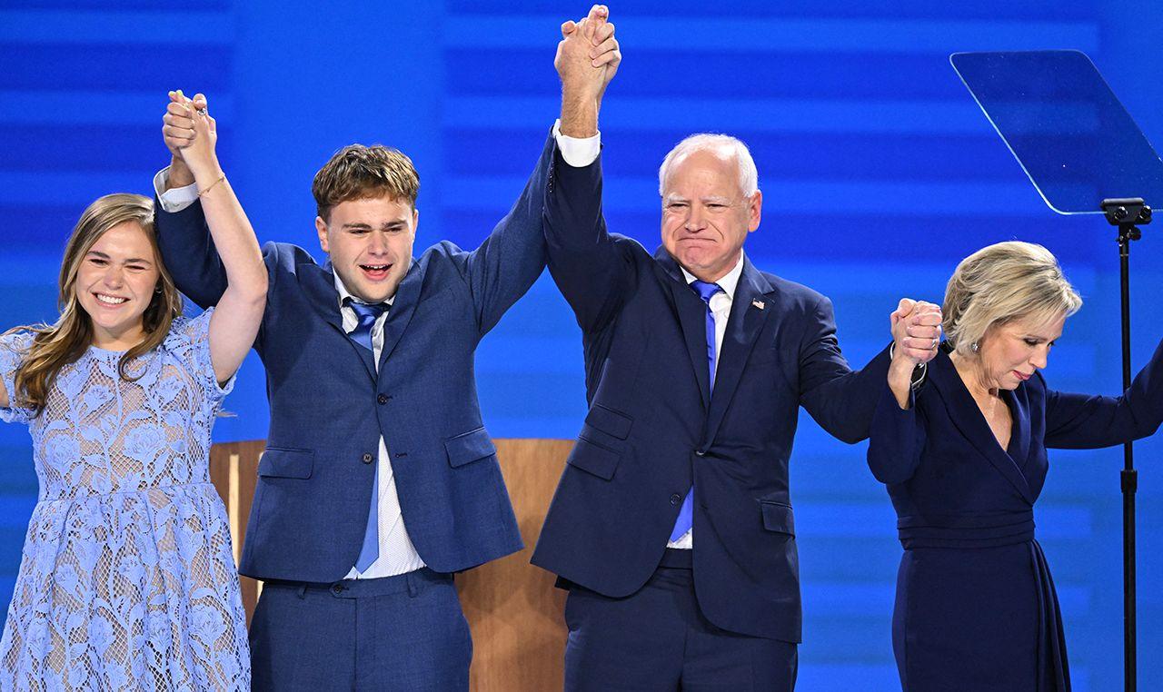 Hope, Gus, Tim and Gwen Walz lock hands while celebrating onstage at the Democratic National Congress in Chicago on 21 August