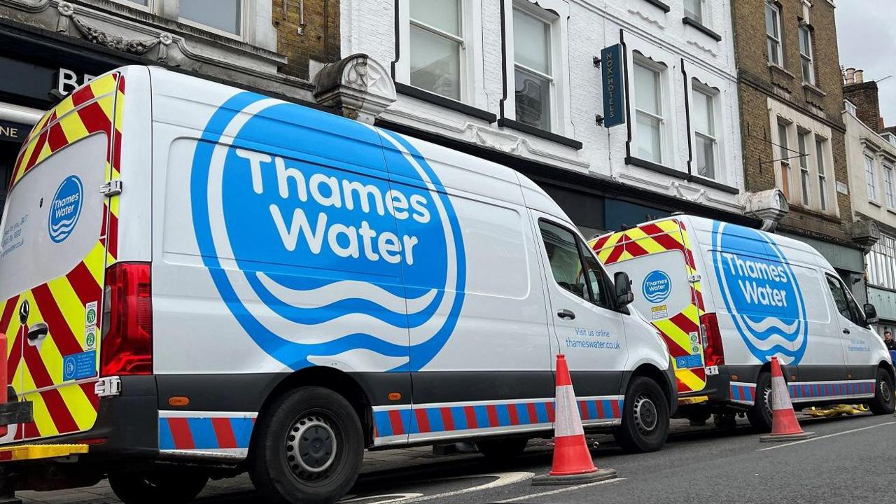 Two Thames Water vans parked on a high street