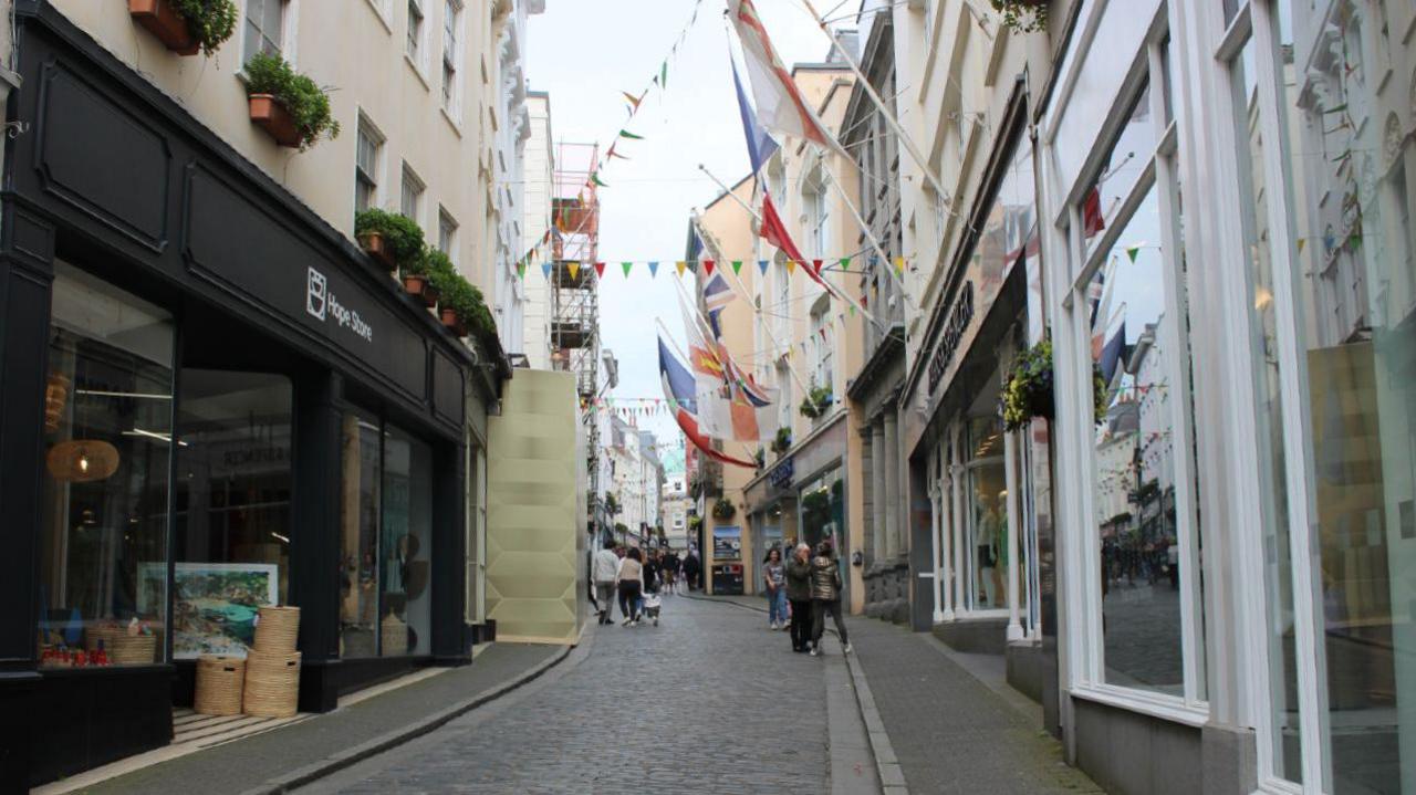 People walking past shops in Guernsey's High Street