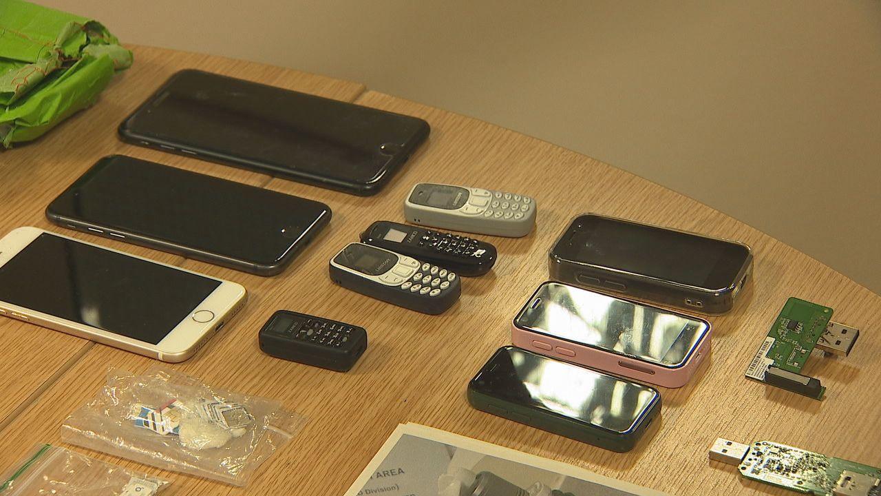 On a rtable, we see a line of three iPhones, four smaller call-only phones, three older iPhone models and several home-made dongles. There is also a small plastic bag full of sim cards - all of which were in the drone's package.