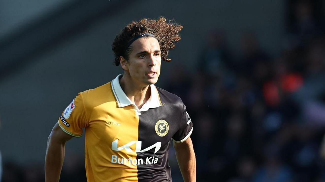 Charlie Webster playing in the amber and black of Burton Albion